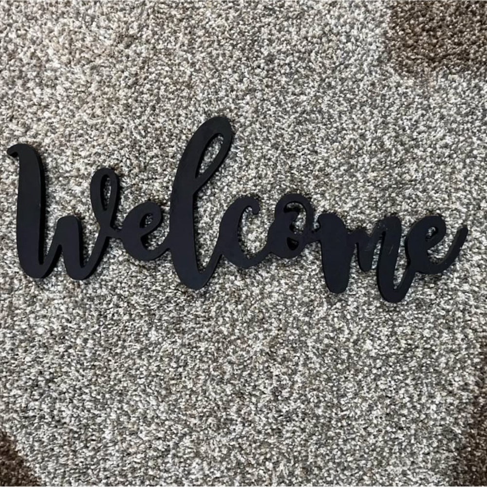 Painted black welcome sign